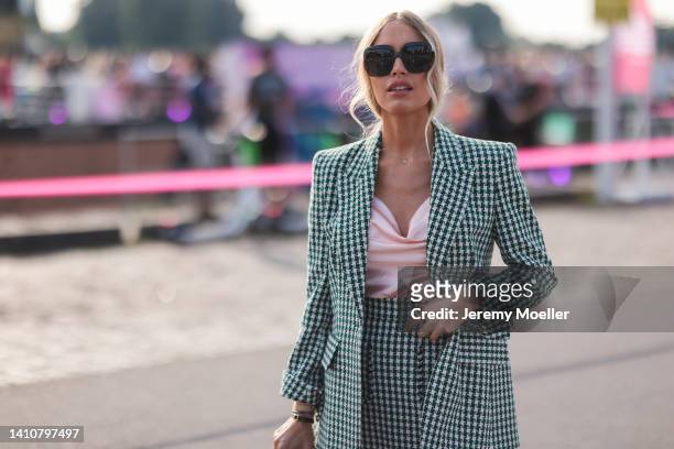 Alena Gerber wearing a matching Riani green blazer and mini skirt and attends the Riani Fashion Festival on July 23, 2022 in Dusseldorf, Germany.