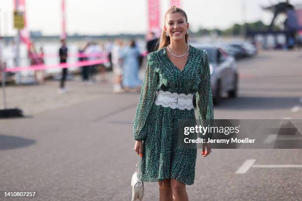 Paulina Swarovski wearing a green mini dress from Riani and attends the Riani Fashion Festival on July 23, 2022 in Dusseldorf, Germany.