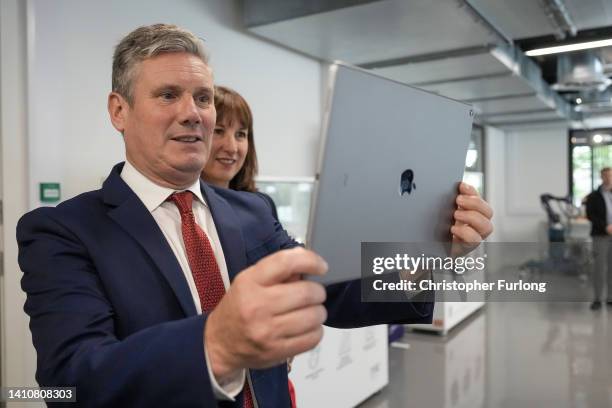 Keir Starmer, leader of the Labour Party and shadow chancellor Rachel Reeves view new technology via an Ipad tablet a during a visit to the...
