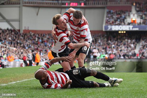 James Coppinger of Doncaster Rovers celebrates his goal with team-mates El-Hadji Diouf and John Oster during their Npower Championship match against...