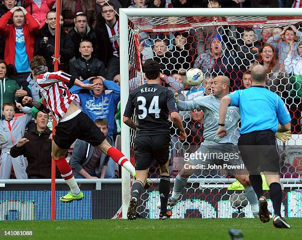 Nicklas Bendtner of Sunderland scores the opening goal during the Barclays Premier League match between Sunderland and Liverpool at Stadium of Light...