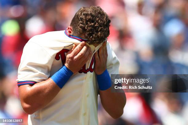 Rhys Hoskins of the Philadelphia Phillies wipes his face after striking out against the Chicago Cubs during the first inning of a game at Citizens...