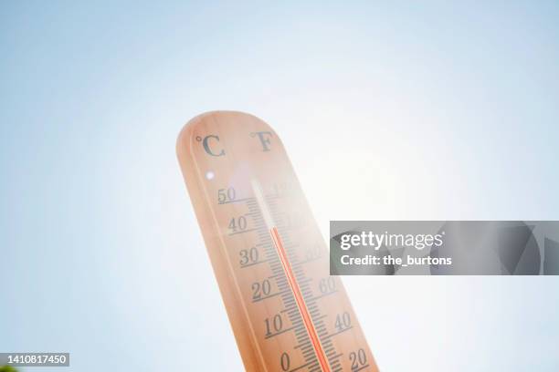 thermometer against sky and sun - weather thermometer stock pictures, royalty-free photos & images