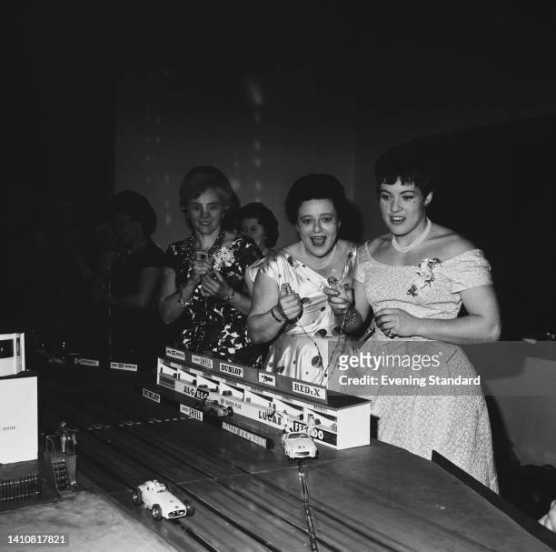 British rally driver Anne Hall , British rally driver Sheila van Damm , British rally driver Pat Moss , slot-car racing with each holding a...