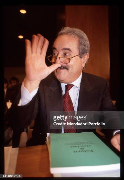 Italian magistrate Giovanni Falcone with his hand raised in greeting. Rome , 1990s