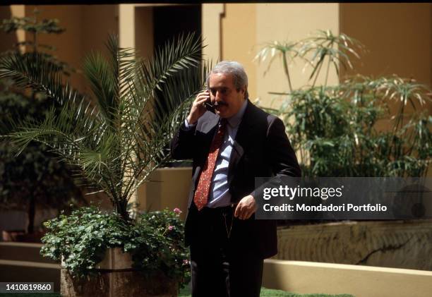 Italian magistrate Giovanni Falcone while he is talking on the cellphone. Rome , May 12th, 1992