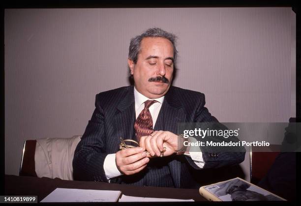 Italian magistrate Giovanni Falcone while looking at the watch. Rome , nineties. 1990s