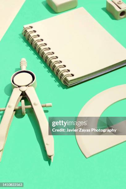 arrangement of yellow stationery on green background - measuring potential business stock pictures, royalty-free photos & images