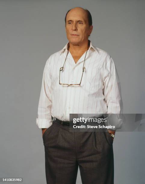 Portrait of American actor Robert Duvall as he poses with his hands in his pockets, Los Angeles, California, 1980s or 1990s.