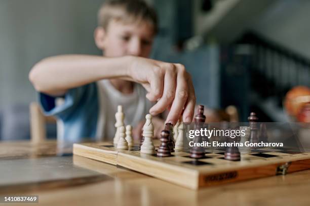 a game of chess. home leisure and board games with children - chairperson stock pictures, royalty-free photos & images