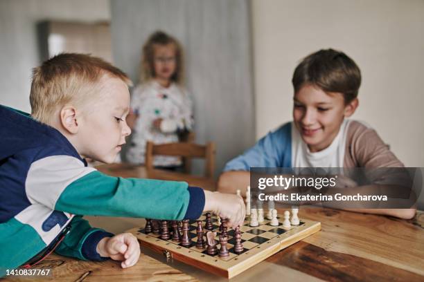 a game of chess. home leisure and board games with children - famille jeux société photos et images de collection