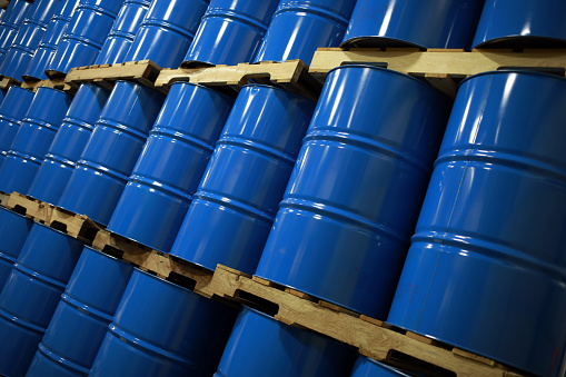 Blue Metal Oil Barrels Stacked In A Warehouse