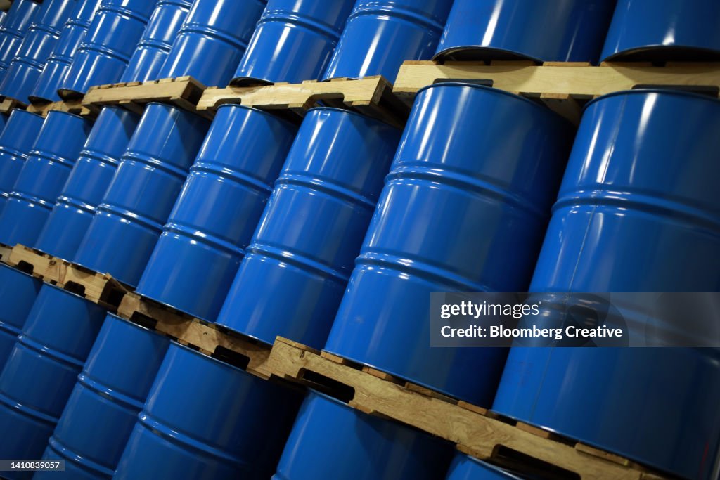 Blue Metal Oil Barrels Stacked In A Warehouse