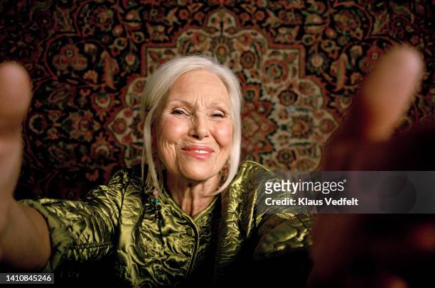 portrait of smiling senior woman taking selfie - tapestry stock pictures, royalty-free photos & images