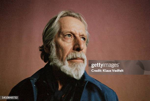 contemplative elderly man with beard - dark blue stock pictures, royalty-free photos & images