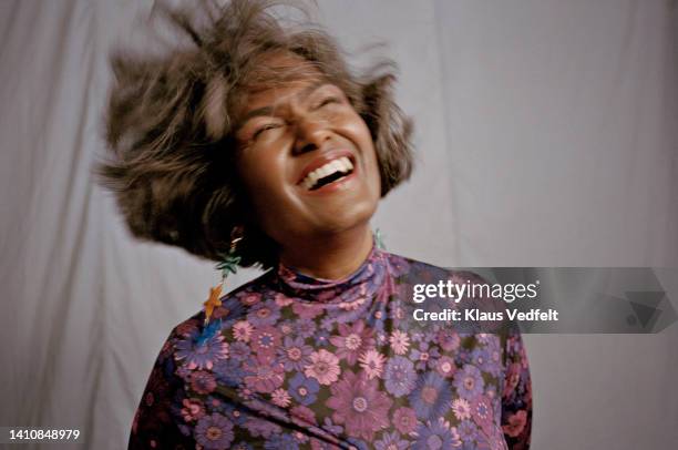 happy fashionable mature woman tossing hair - scuotere i capelli foto e immagini stock