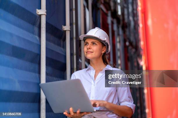 the business woman working with the computer laptop for checking the information in cargo container terminal. - containerhafen stock-fotos und bilder