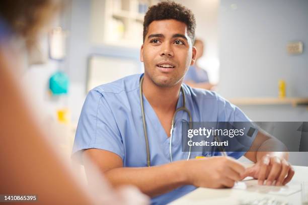 junior doctor with patient - junior doctor stock pictures, royalty-free photos & images