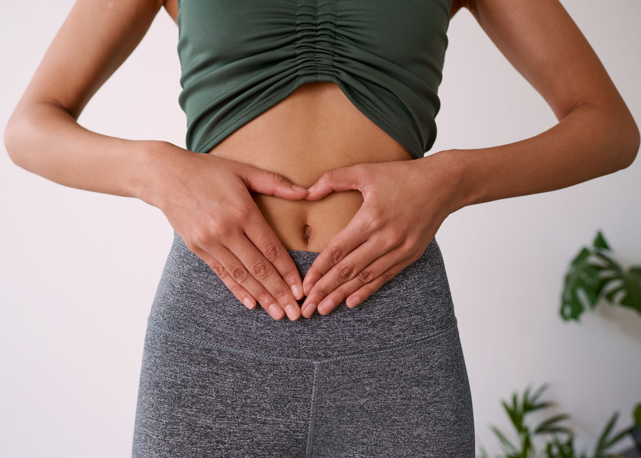 Close up of a multi-ethnic woman's hands on her stomach Close up of a multi-ethnic woman's hands on her stomach