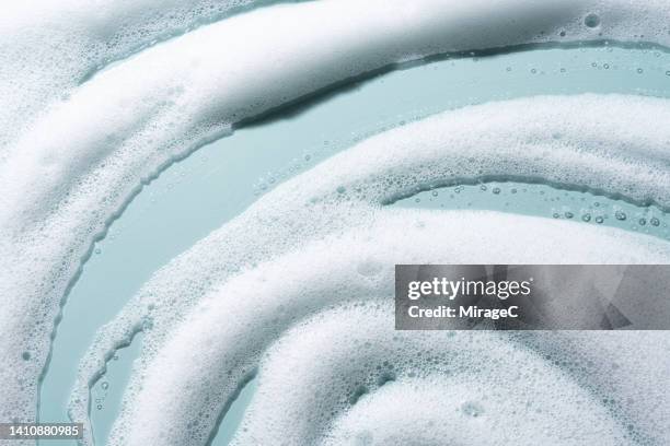 white foam soap suds texture background - blue swirls with bubbles stock pictures, royalty-free photos & images