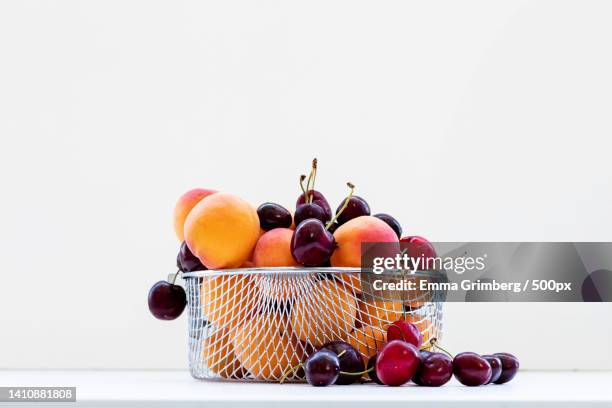 sweet cherries with apricots isolated on white background cutout ripe - fruit bowl stock pictures, royalty-free photos & images