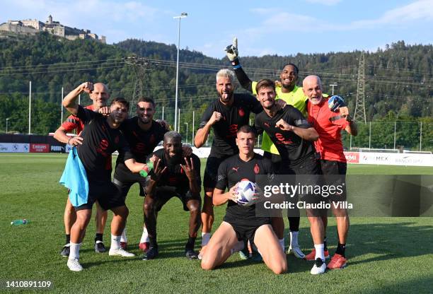 The winning team poses for the photo during a AC Milan training session on July 25, 2022 in Villach, Austria.