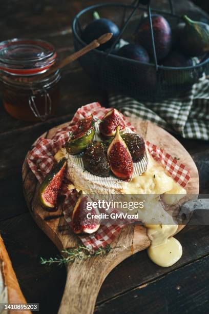 baked camembert cheese with fresh figs - baked brie stock pictures, royalty-free photos & images