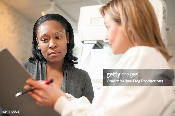 nurse with patient signing consent for mammogram - mammografi bildbanksfoton och bilder