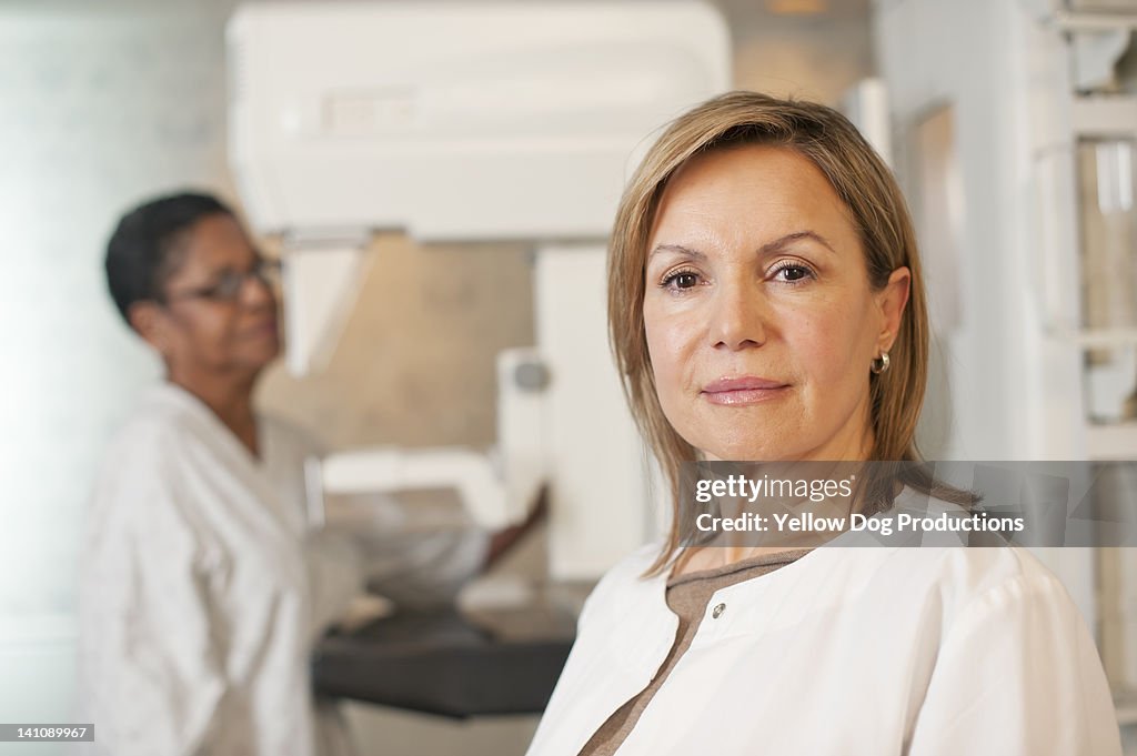 Medical Technician in front of Mammogram Machine