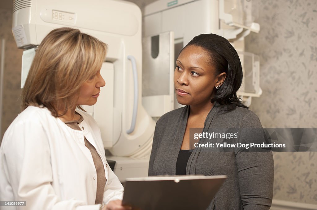 Nurse with patient going over mammogram procedure