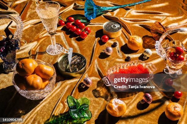 xmas modern dinner table setting on gold velvet fabric background. creative merry christmas celebration concept. contemporary new year festive backdrop - 魚卵 ストックフォトと画像