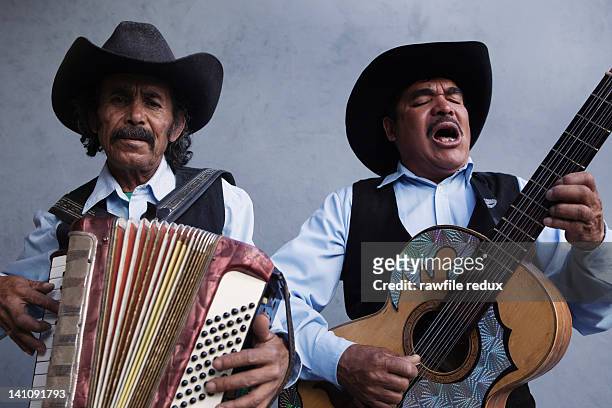 two mexican musicians singing - accordion instrument stockfoto's en -beelden