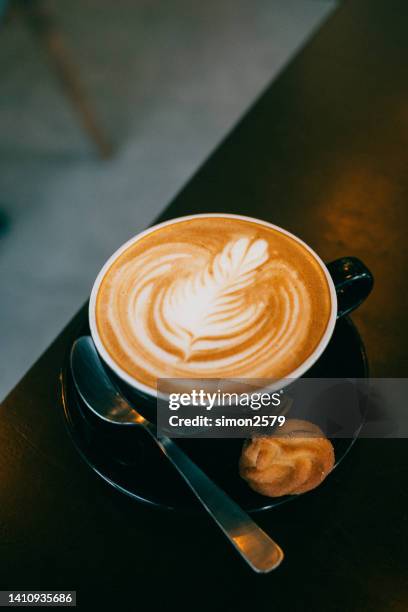 image of hot latte coffee with latte art on wooden table - coffee art stock pictures, royalty-free photos & images