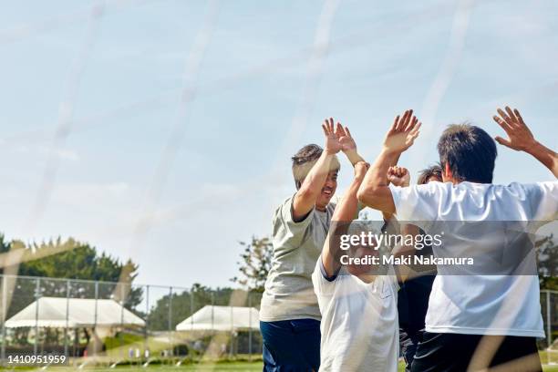 a middle-aged uncle who enjoys playing soccer on holidays. - association of east asian relations and japan stock pictures, royalty-free photos & images