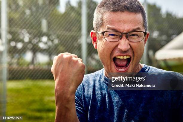 a middle-aged uncle who enjoys playing soccer on holidays. - shouting ストックフォトと画像