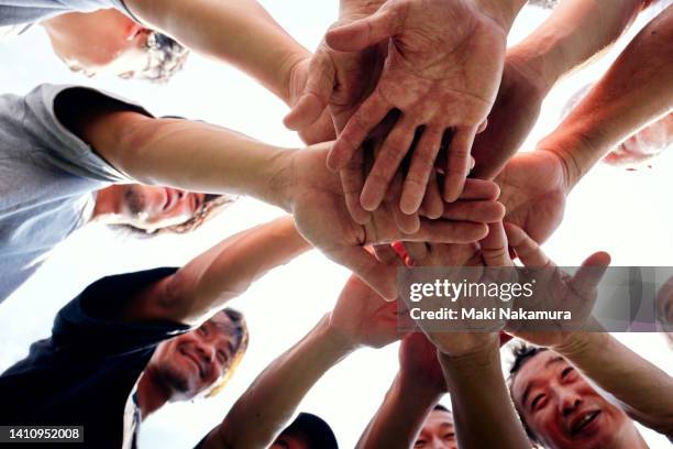 a middle-aged uncle who enjoys playing soccer on holidays. - hands together stock pictures, royalty-free photos & images