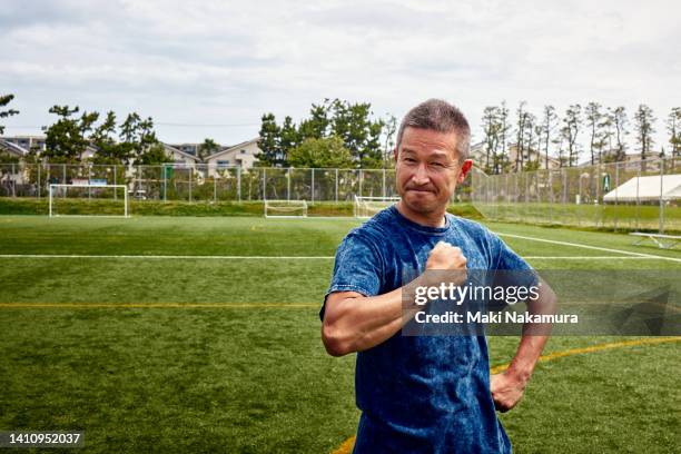 a middle-aged uncle who enjoys playing soccer on holidays. - punching the air stock pictures, royalty-free photos & images