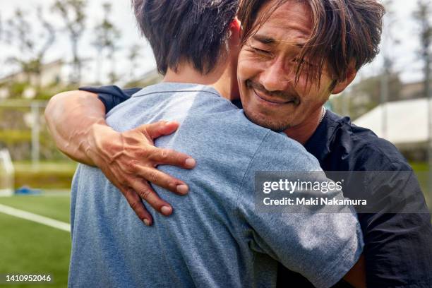 a middle-aged uncle who enjoys playing soccer on holidays. - team encouragement stock pictures, royalty-free photos & images