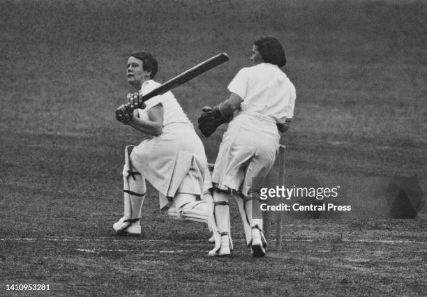 Wicketkeeper Alice Wegemund from Australia looks on from behind the stumps as Betty Archdale , team captain and right- handed batter for the Kent and...