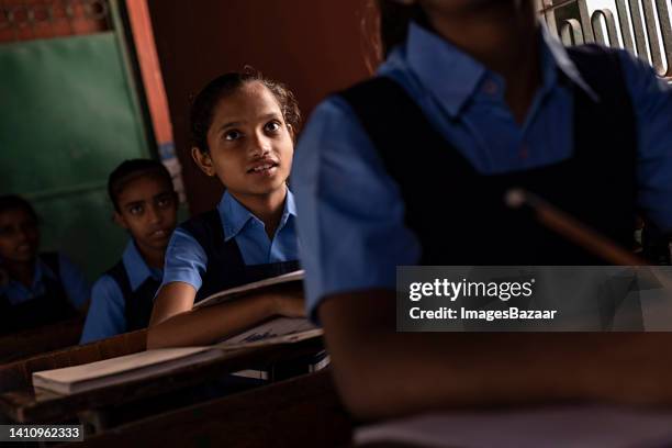 school girls studying in a classroom - schoolgirl photos et images de collection