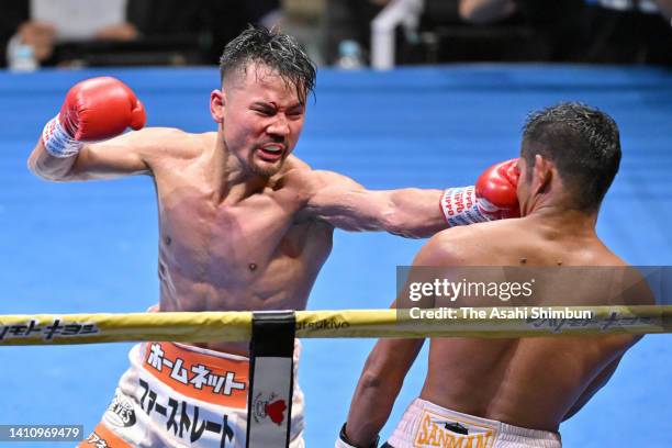 Daigo Higa of Japan connects his left on Froilan Saludar of the Philippines in the 8th round during the bantamweight bout at Ota-City General...