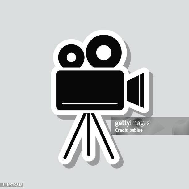 movie camera with tripod. icon sticker on gray background - television camera 幅插畫檔、美工圖案、卡通及圖標