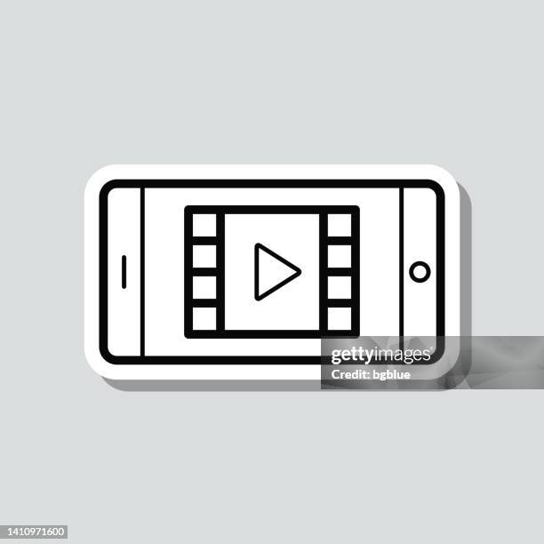 stockillustraties, clipart, cartoons en iconen met watch video on smartphone. icon sticker on gray background - looking at camera