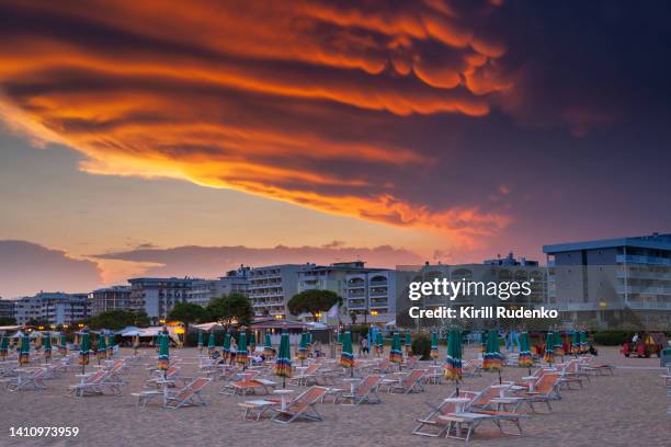 dramatic sunset over the beach in bibione, italy - bibione stock pictures, royalty-free photos & images