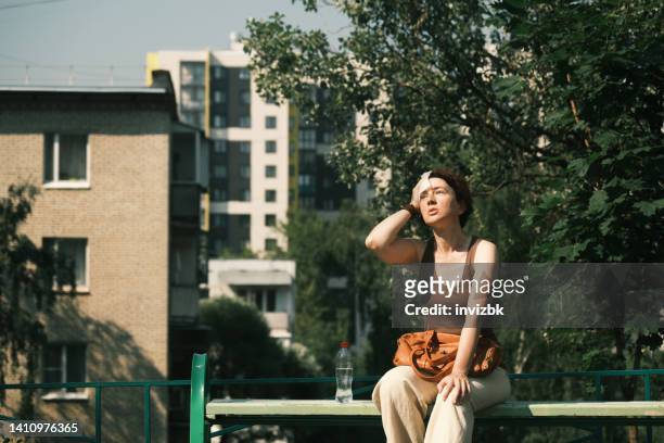 woman suffering from heat wave - heat imagens e fotografias de stock