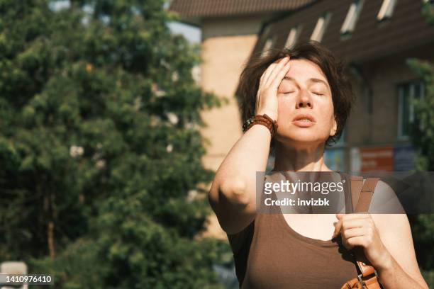 woman suffering from heat wave - vertigo stock pictures, royalty-free photos & images