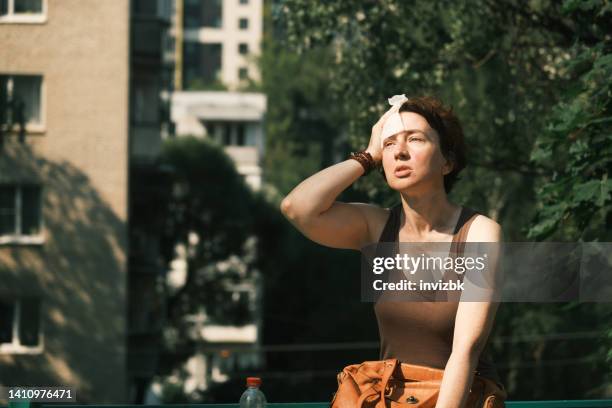 woman suffering from heat wave - overheated stock pictures, royalty-free photos & images