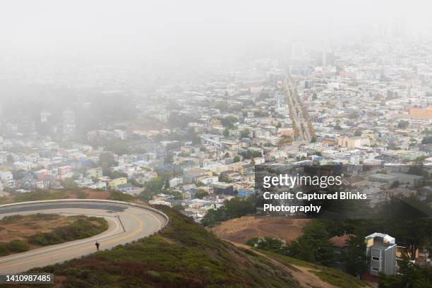 young man running up the mountain in san francisco at sunrise - twin peaks stock pictures, royalty-free photos & images