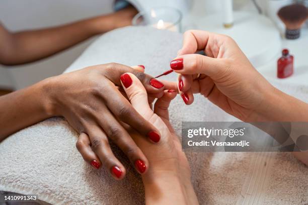 close up of female hands having manicure treatment - nail salon stock pictures, royalty-free photos & images