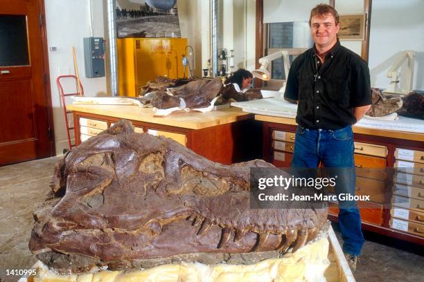 Paleontological Bruce Schumacher stands alongside the fossilized bones of a Tyrannosaurus rex skeleton dubbed "Sue" May, 1998 at the Field Museum of...